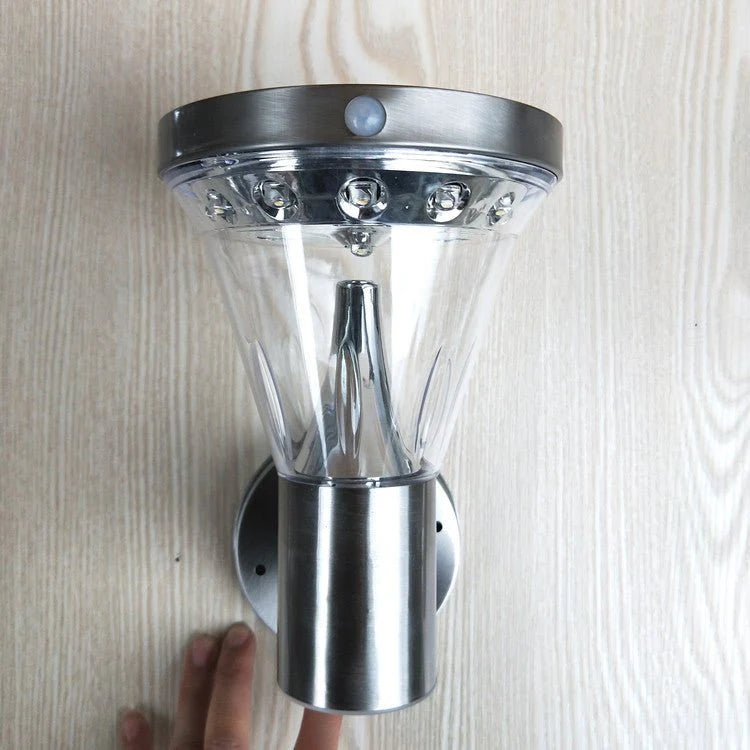 Solar Wall Light fixture with motion sensor on a wooden surface