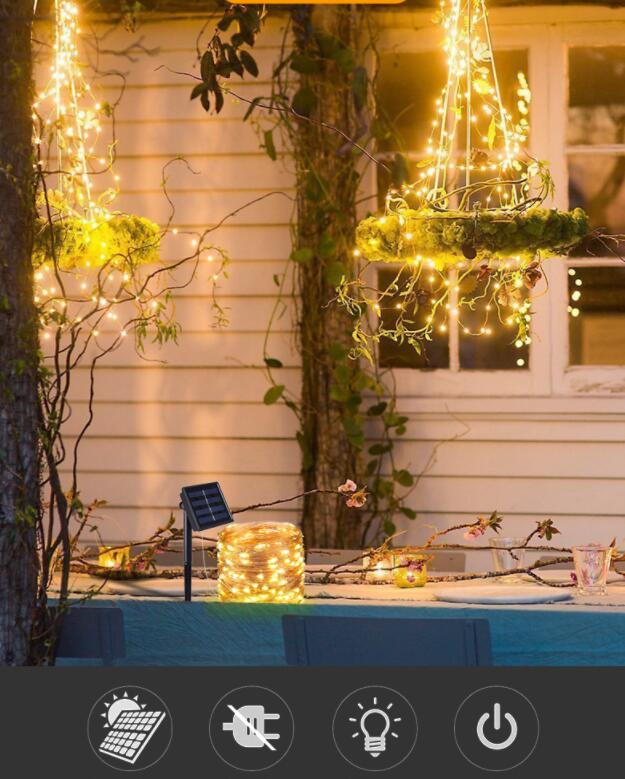 Outdoor setting with string lights and a table, featuring a control panel at the bottom.