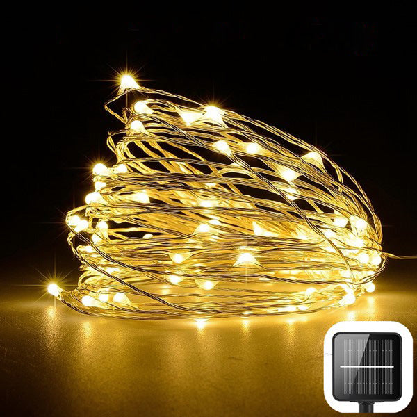 Coiled string of small lights with a solar panel indicator on a dark background