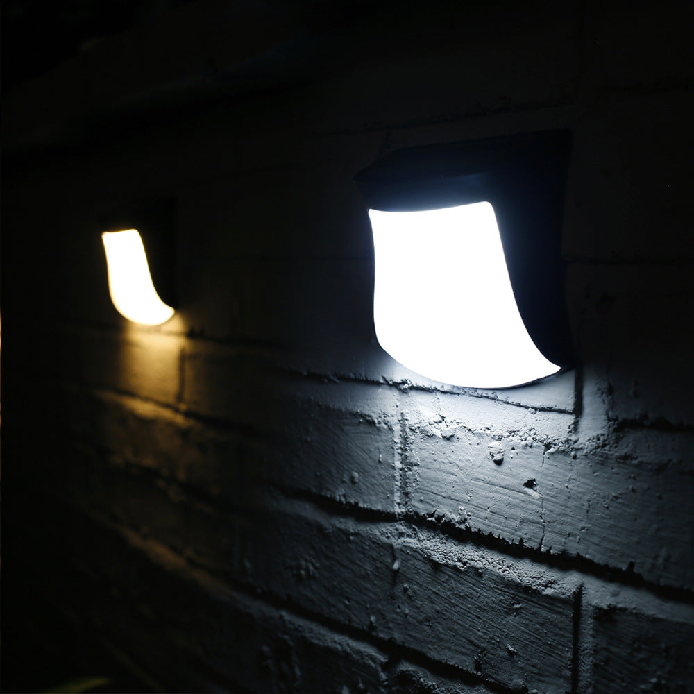 4pcs Solar Lamp Fence Wall Lamp Outdoor Waterproof Home Decoration Lighting Garden Wall Lamp on a brick wall in a dark setting