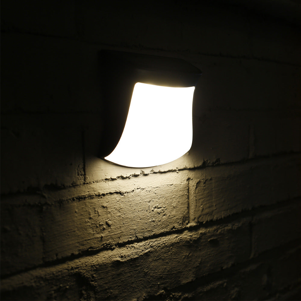 4pcs Solar Lamp Fence Wall Lamp Outdoor Waterproof Home Decoration Lighting Garden Wall Lamp Light fixture on a brick wall in a dark setting