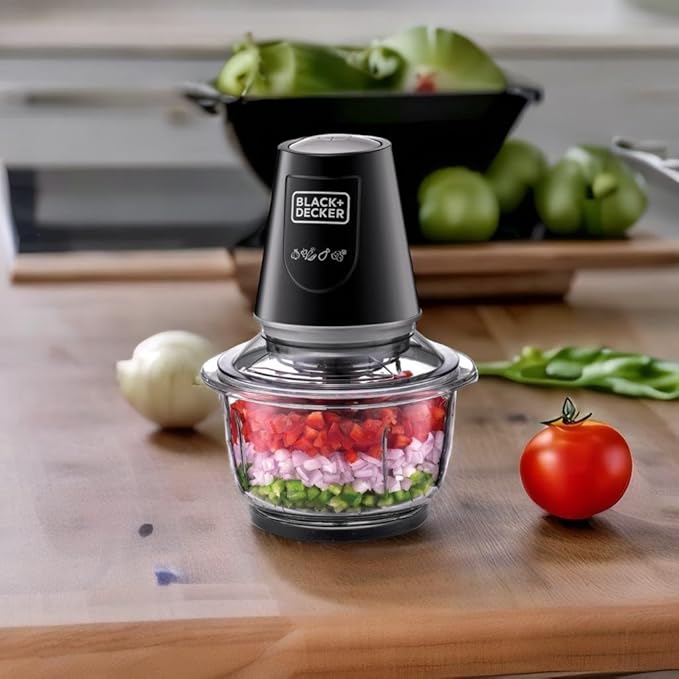Black+Decker food chopper with chopped vegetables on a wooden surface