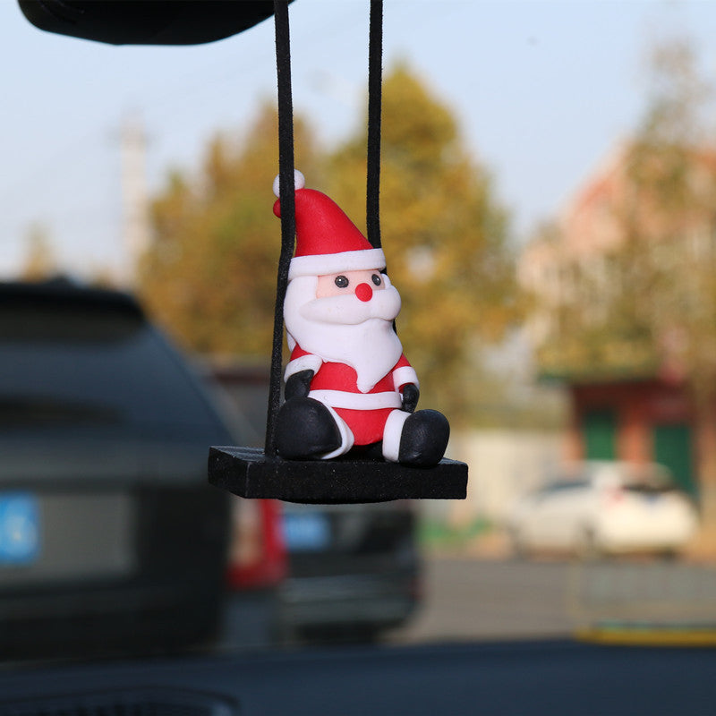 Christmas Car Rearview Mirror Pendant Santa Claus car hanging ornament on a blurred outdoor background