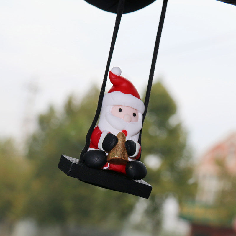 Christmas Car Rearview Mirror Pendant Santa Claus ornament on a swing with a blurred outdoor background