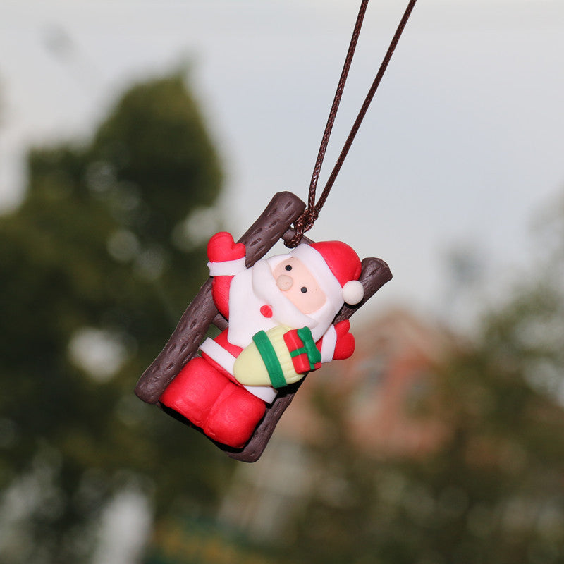 Christmas Car Rearview Mirror Pendant Santa Claus ornament on a branch with a blurred natural background