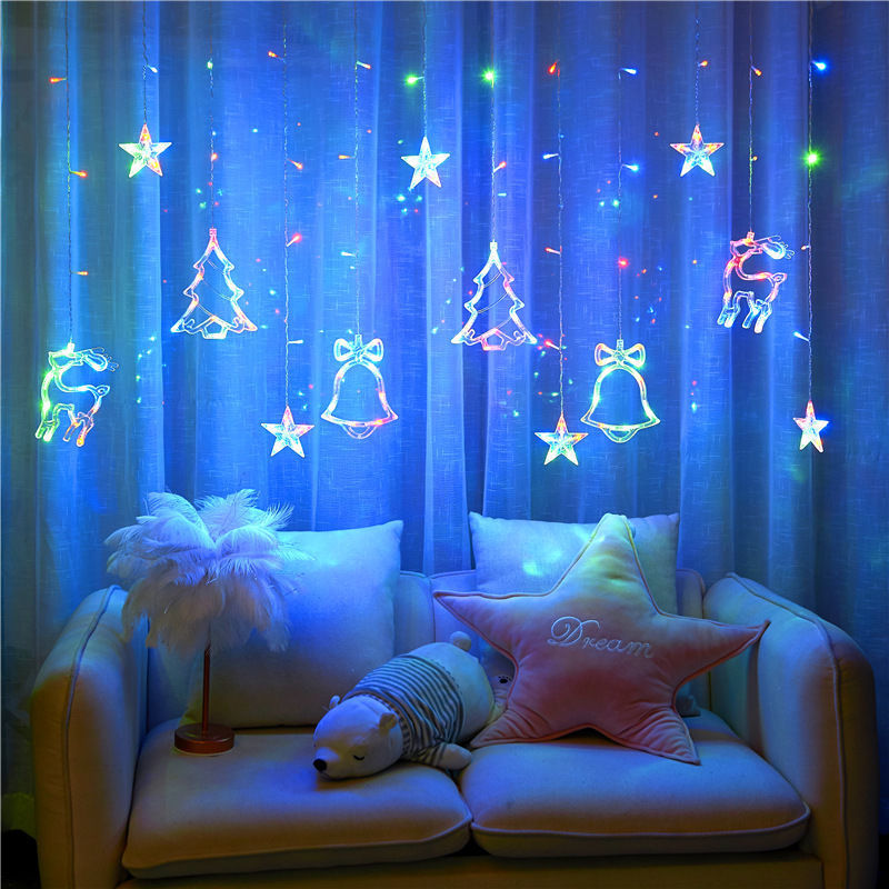 Decorate Christmas Tree Hanging Lamp in Bedroom Curtain Lamp Decorative string lights with star, tree, and bell shapes on a blue curtain background.