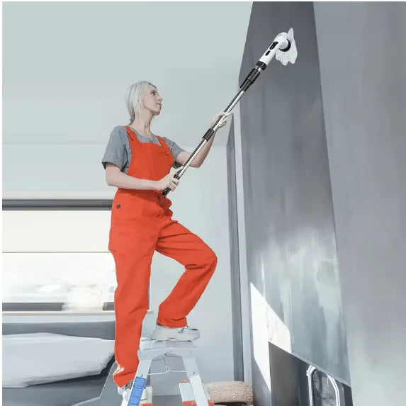 Person cleaning a ceiling with a long-handled Electric Cleaning Brush in a modern room.