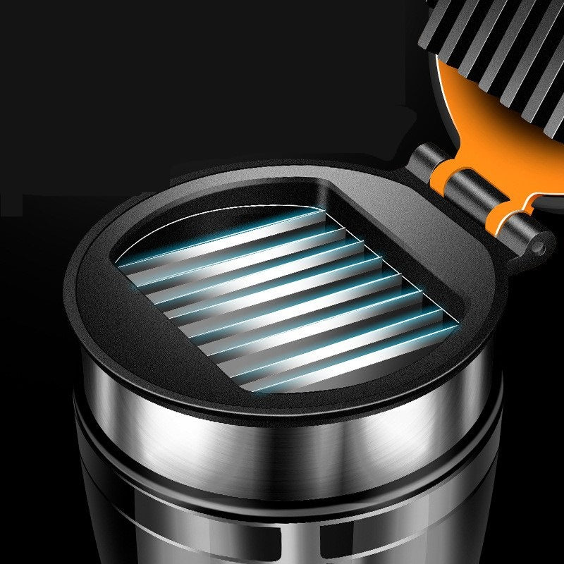 Close-up of a Kitchen Gadget With Integrated Fruit Cutter with a black cover and orange handle on a black background.