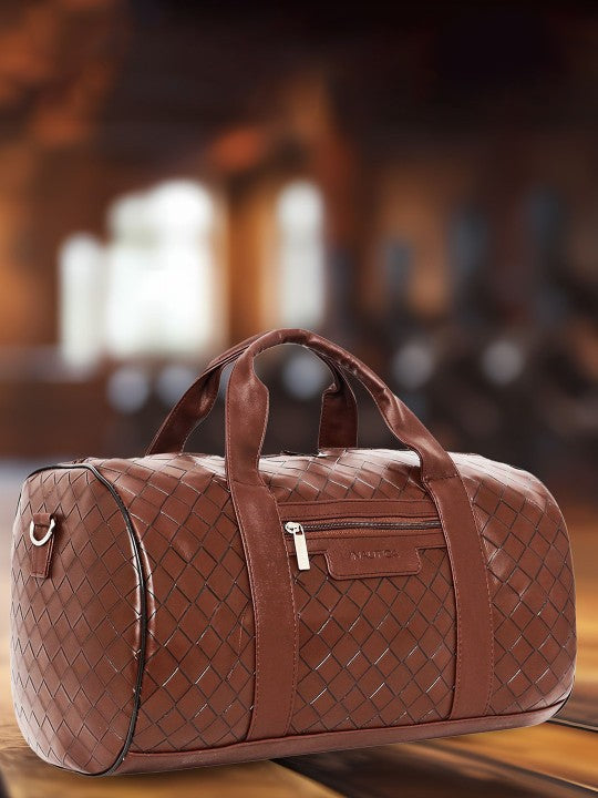Brown woven duffel bag on a wooden surface with a blurred background