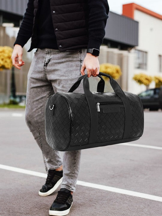 Person holding a black Nautica - Casual Duffel Bag on a street