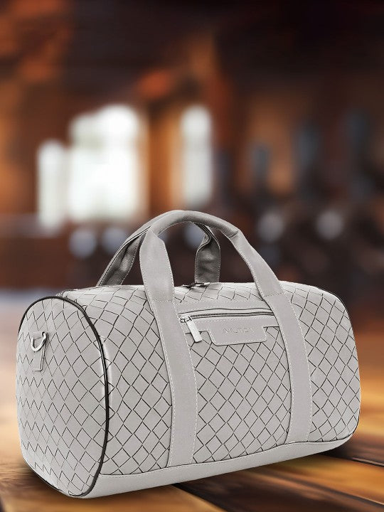 Gray Nautica Casual Duffel Bag with a diamond pattern on a wooden surface with a blurred background