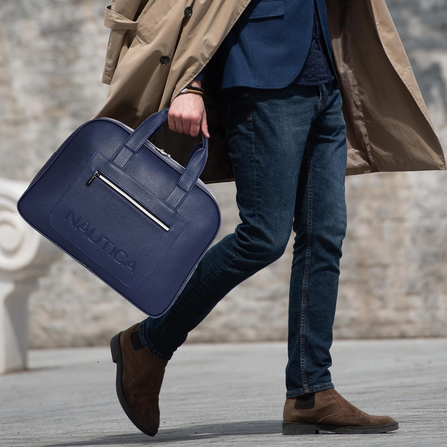 Person holding a blue Nautica bag with a blurred background