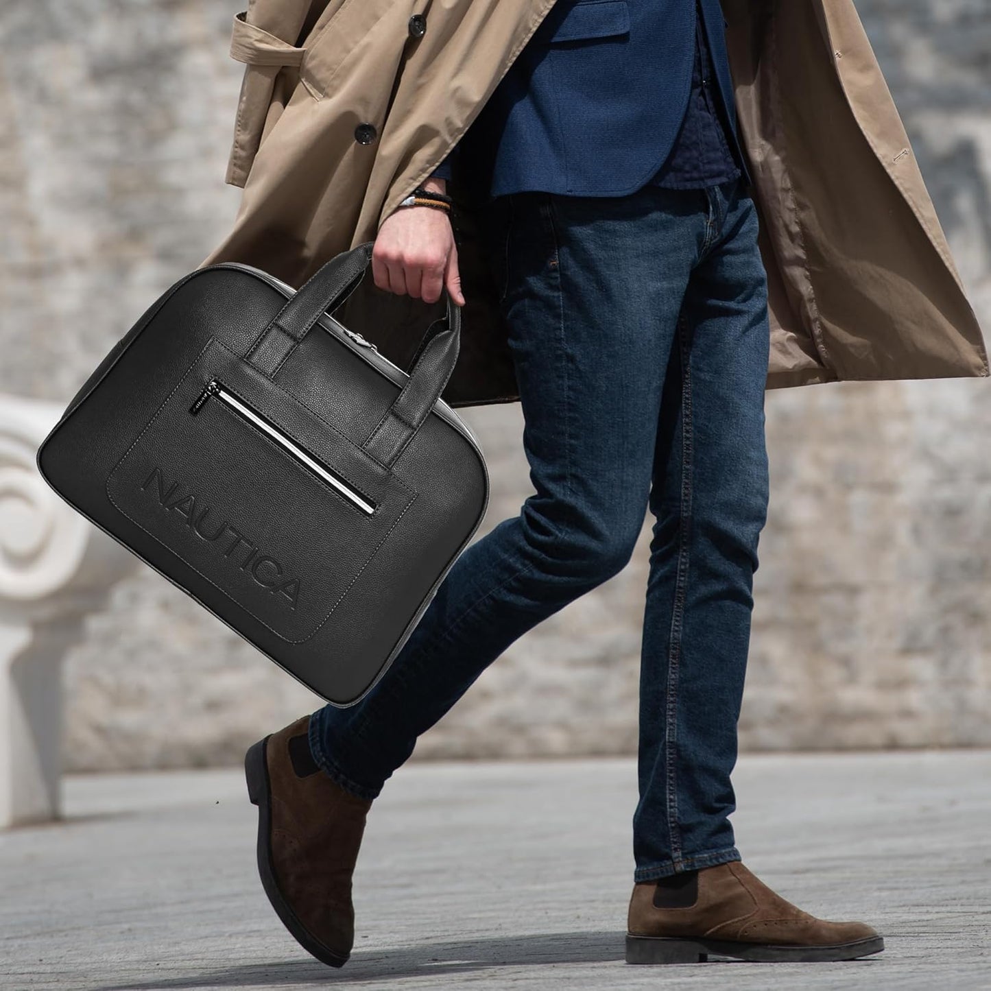 Person holding a black Nautica briefcase with a blurred background