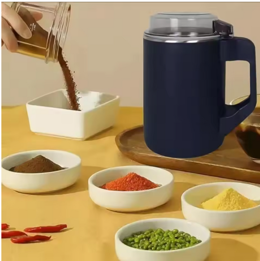 Navy blue Electric Grinder for Coffee & beans with a handle on a wooden surface, surrounded by small bowls of spices and ingredients.