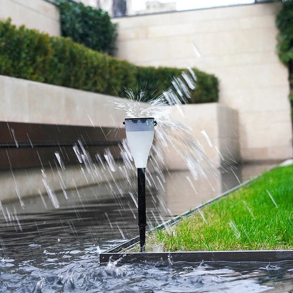 Solar Outdoor Water Decorative Street Light on a grassy area in rain 