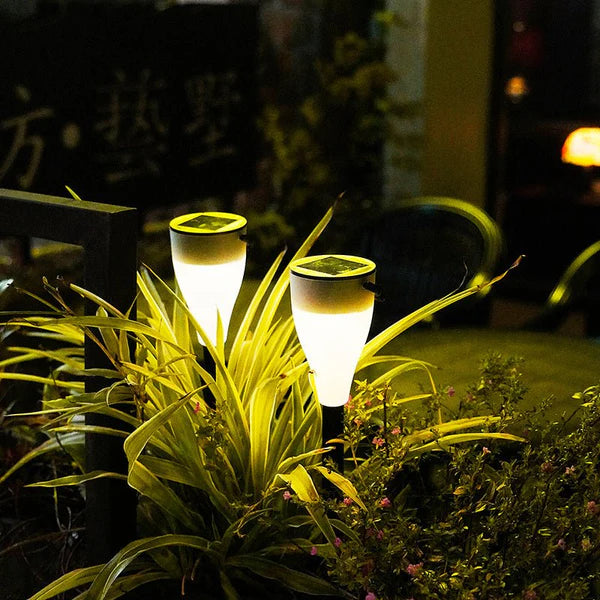 Two Solar Outdoor Water Decorative Street Light illuminating a garden at night.