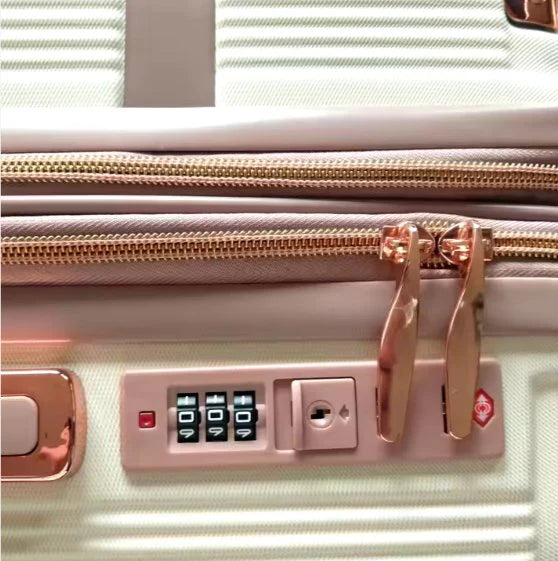 Close-up of a Custom Travel Luggage with a rose gold handle and keypad lock on a light background