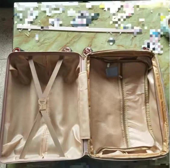 Open beige Custom Travel Luggage bag with interior details on a camouflage background