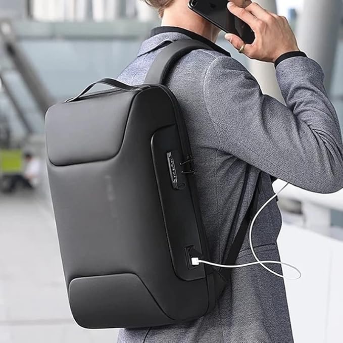 Person wearing a black "digital backpack with type C" backpack with a USB cable, using a smartphone in an urban setting.