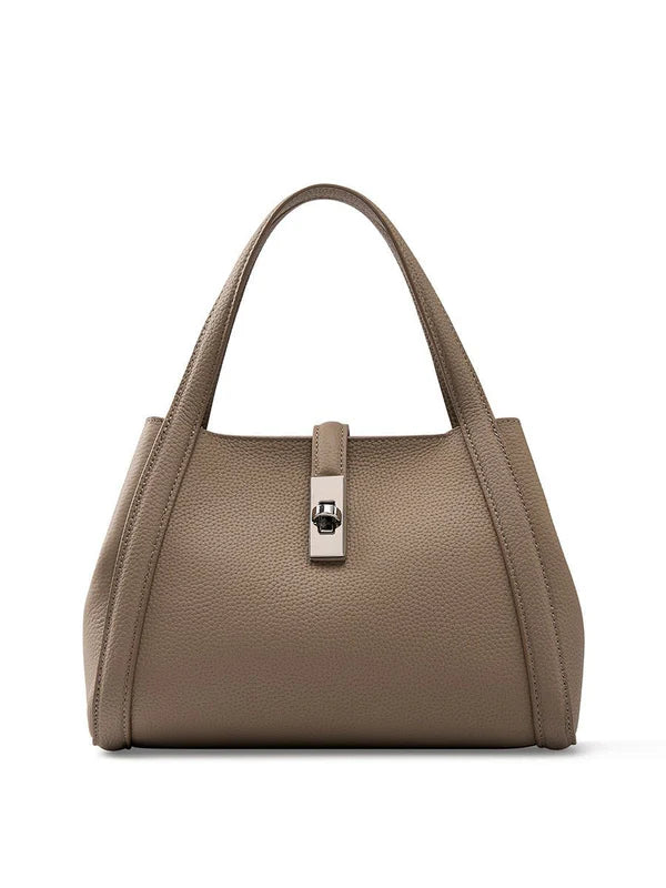 Beige color fashionable Korean style large capacity leather handbag with a silver clasp on a white background
