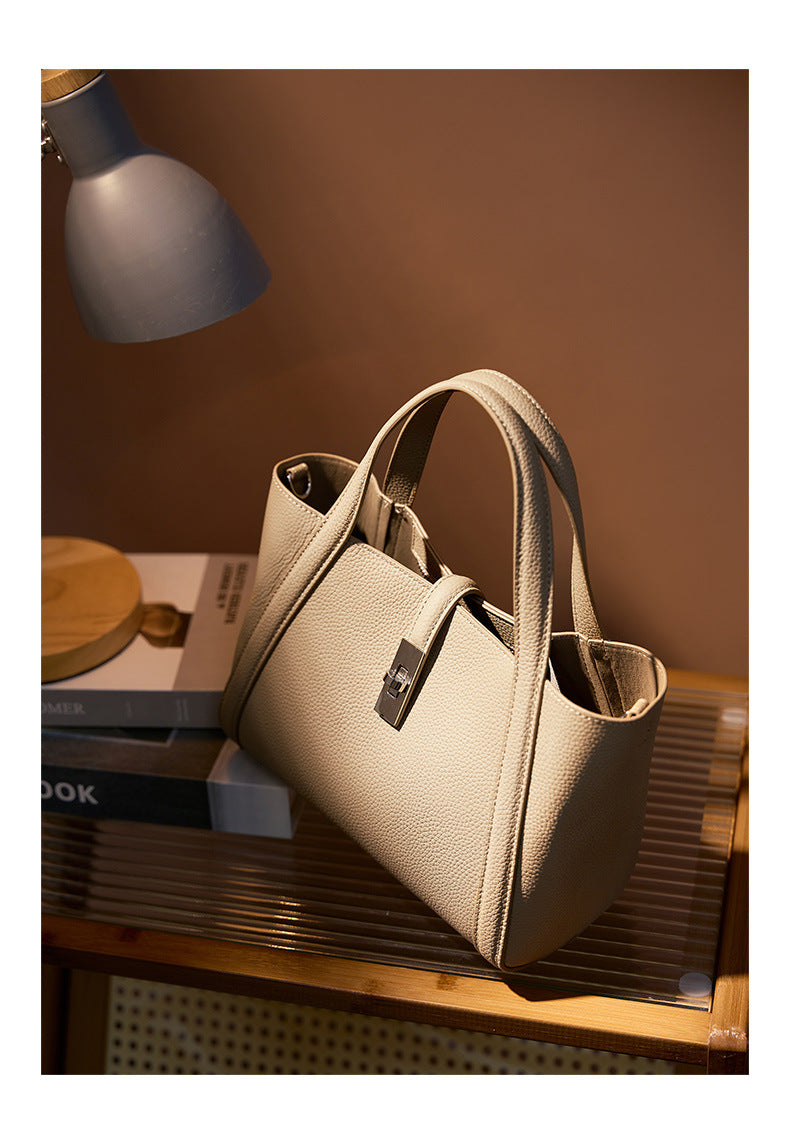 Beige color handbag fashionable style large capacity on a wooden surface with a warm light source