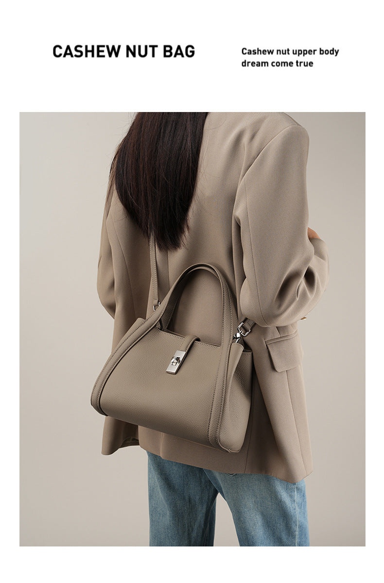 Person wearing a cashew nut coat with a matching fashionable Korean style large capacity handbag on a plain background