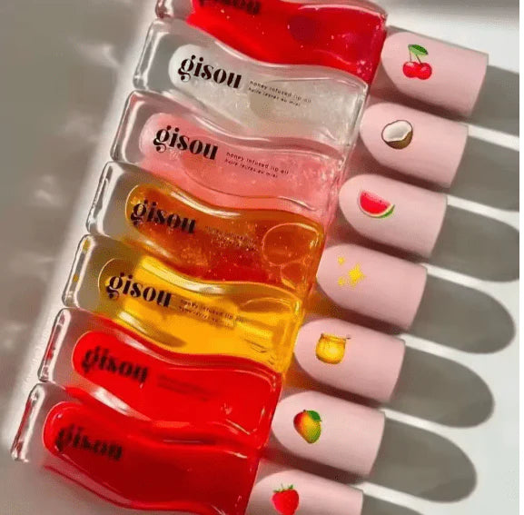 Set of gisou honey infused lip oil bottles with different flavor  art designs on a white background