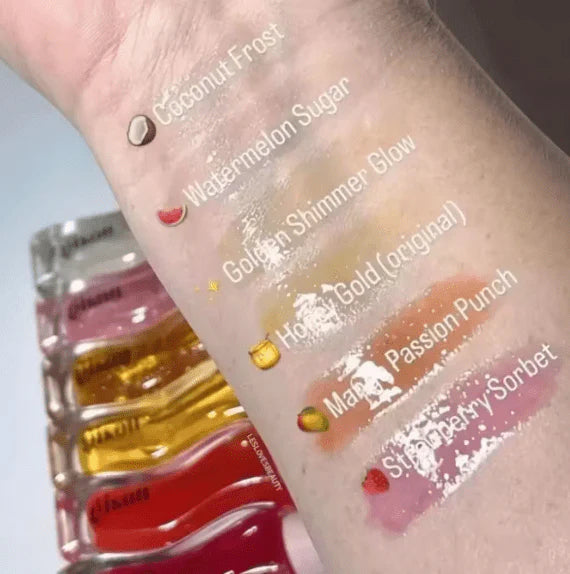 gisou honey infused lip oil swatches on a hand with product names labeled