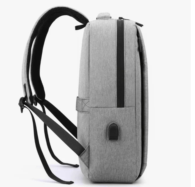 A Gray "nylon backpack" with a USB port on a white background