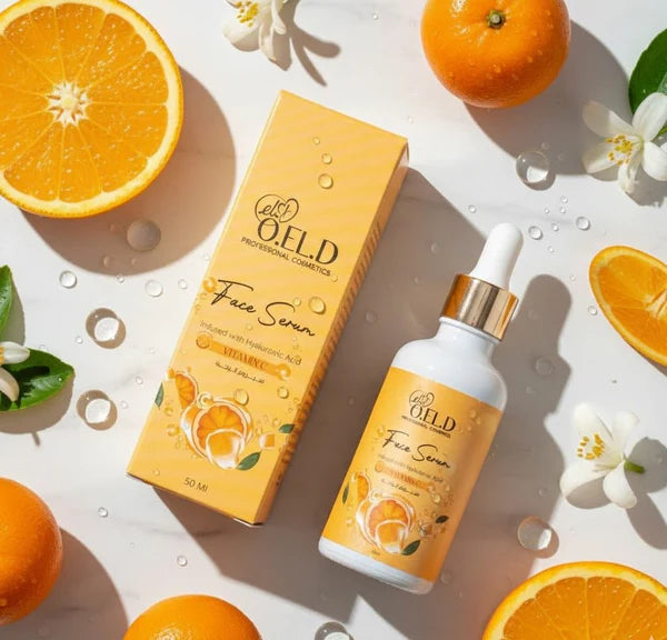 OELD face serum bottle and packaging with oranges and flowers on a light background