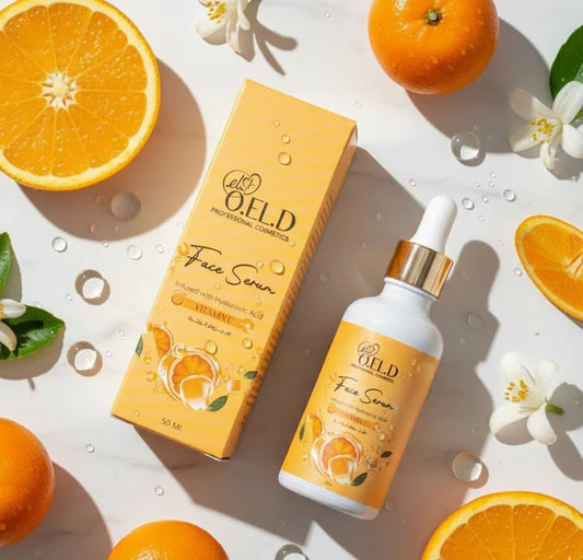 OELD face serum bottle and packaging with oranges and flowers on a light background